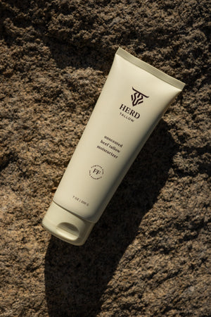 Tube of HERB Skincare product on a textured brown surface